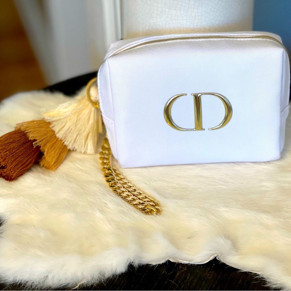 Dior white canvas wristlet with gold chain and tassel keychain & gold CD emblem.